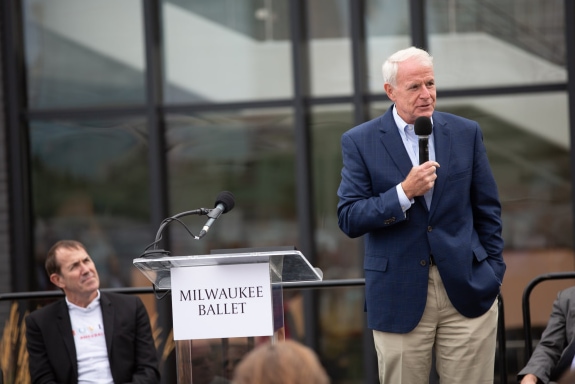 a man making a speech, in a suit