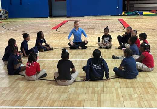 Children sit in a circle