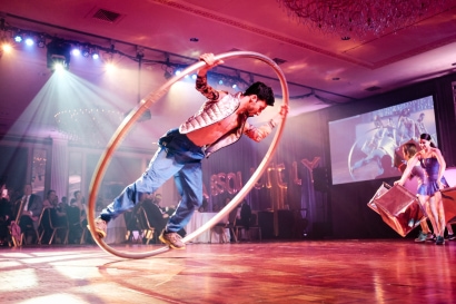 man performs in a spinning giant hoop
