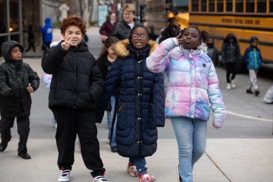 Three students board their bus after a performance of Milwaukee Ballet's