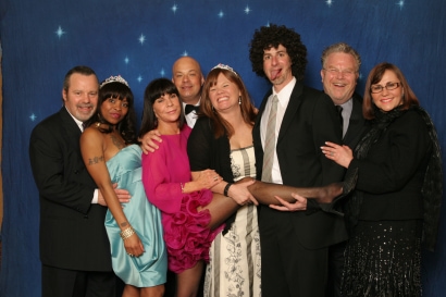 eight guests posing and smiling for a photo in 2011