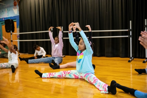children stretching in ballet class