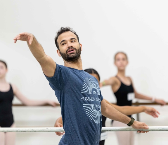 a teacher, and company dancer Randy Crespo, demonstrating a combination in class