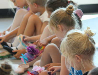 young dancers decorating pointe shoes