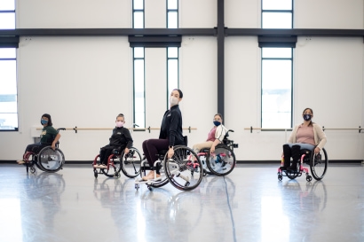 a group of people in wheelchairs, in a ballet studio
