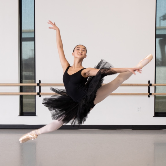 a person in a tutu jumping in the air